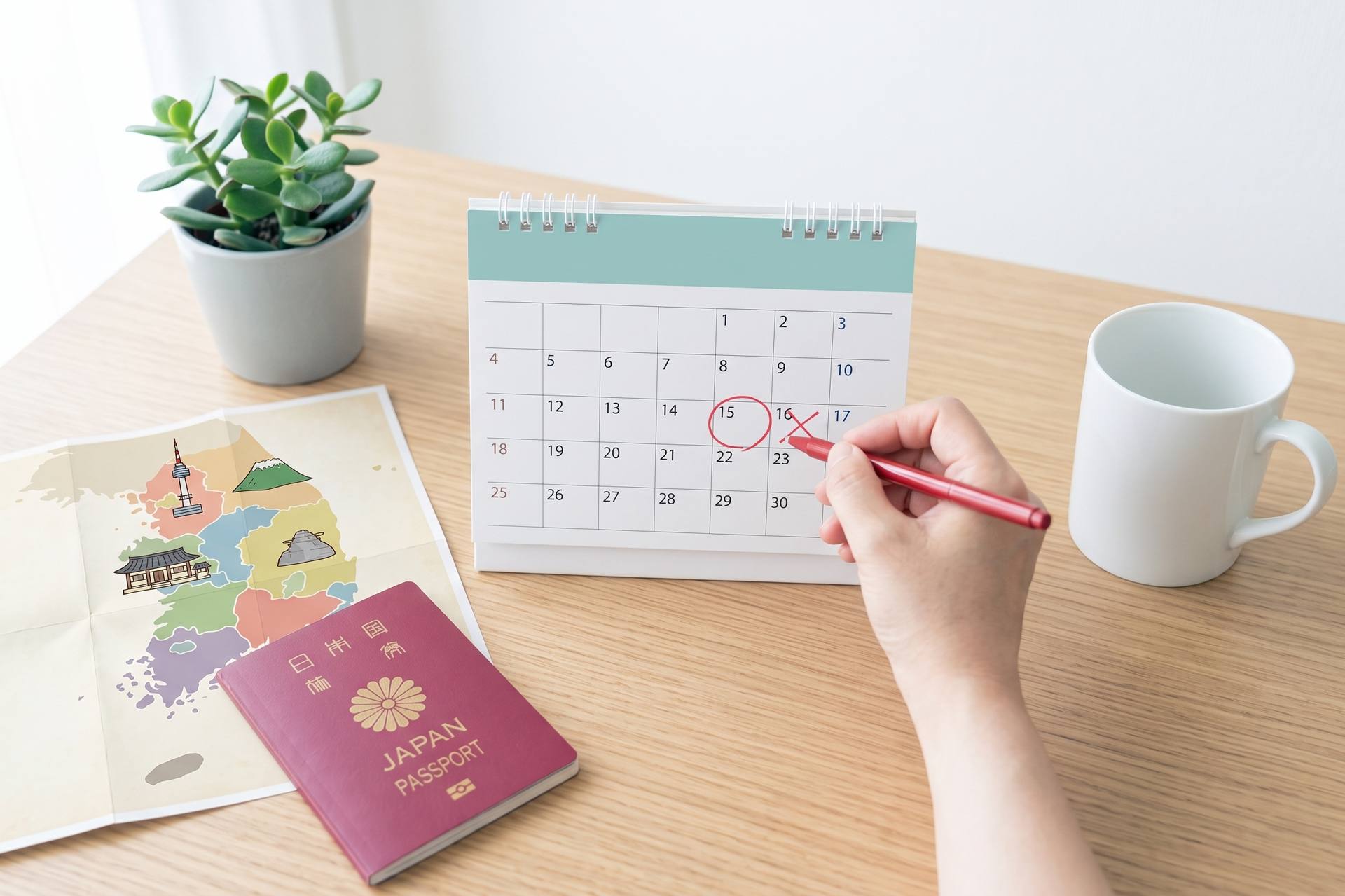 旅程表に韓国旅行の予定を書き込む手元